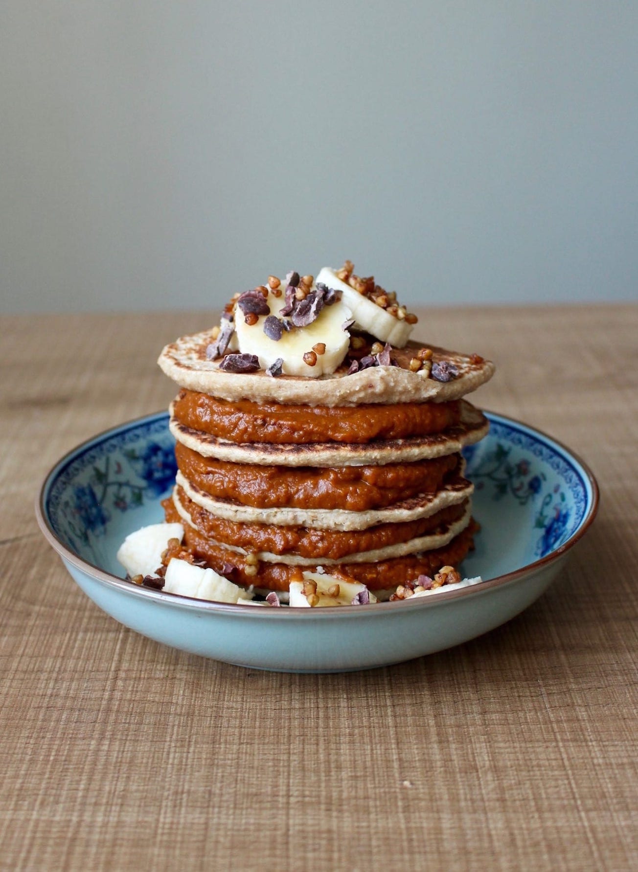 2 ingredient oatmeal banana blender pancakes layered with pumpkin chocolate spread.