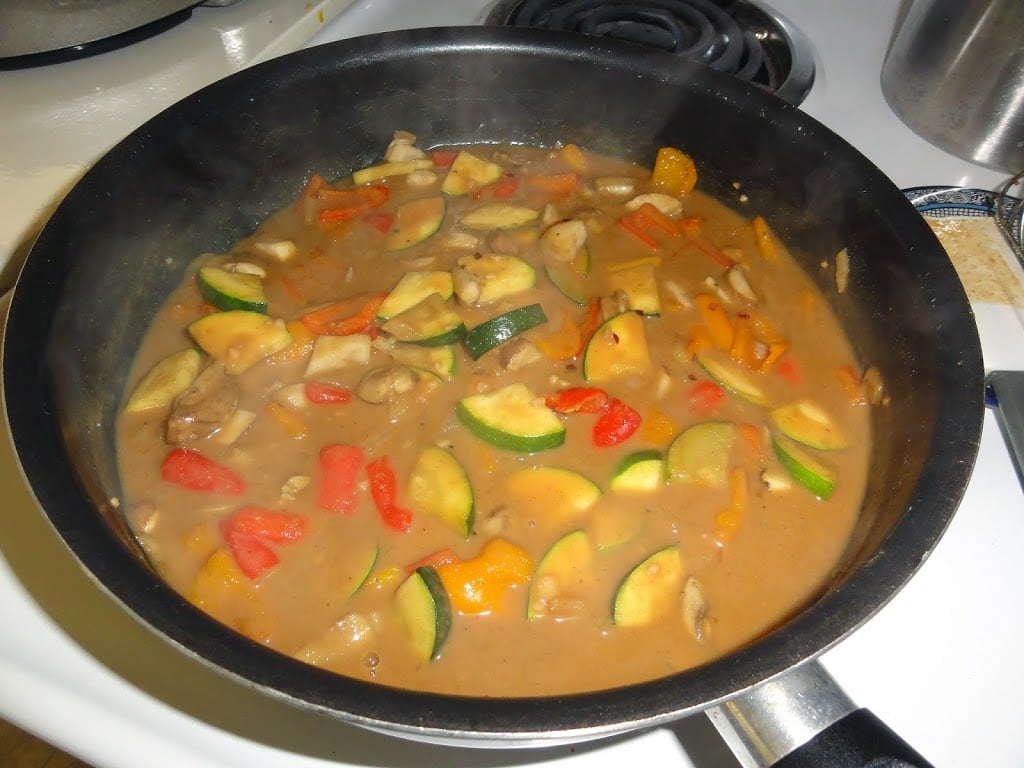 Indonesian peanut sauce simmering in a skillet