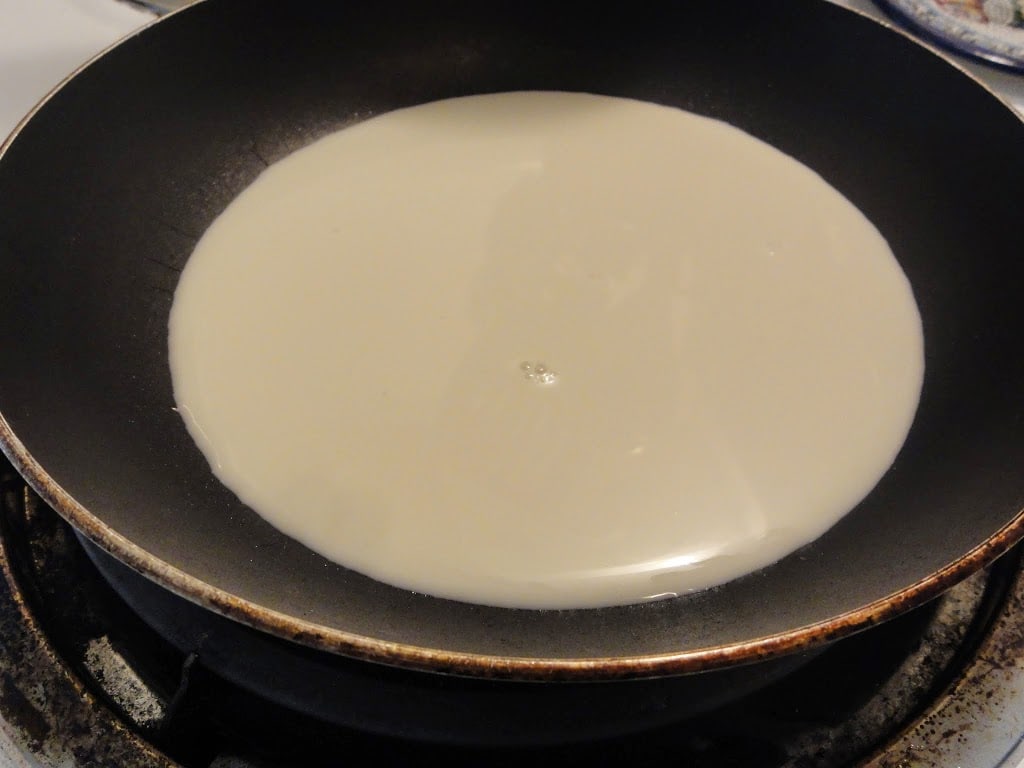 almond milk in a saucepan on a burner