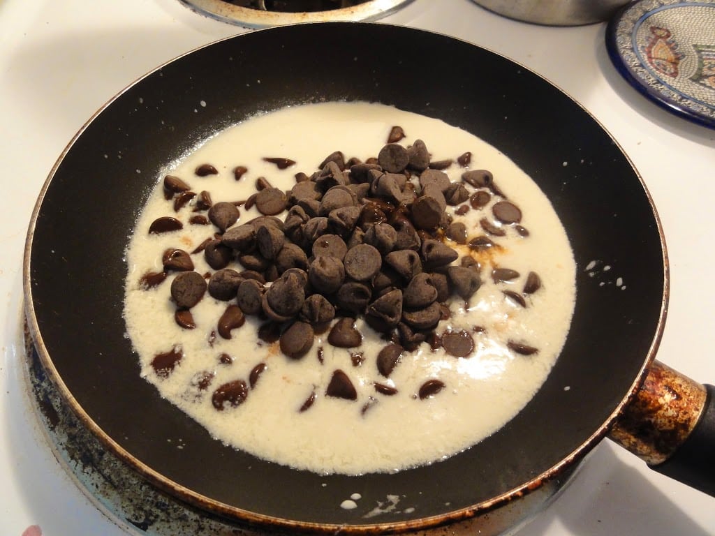 almond milk and chocolate chips in a skillet