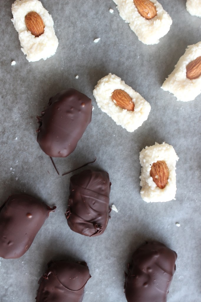 an above view of homemade almond joys before and after being coated in dark chocolate
