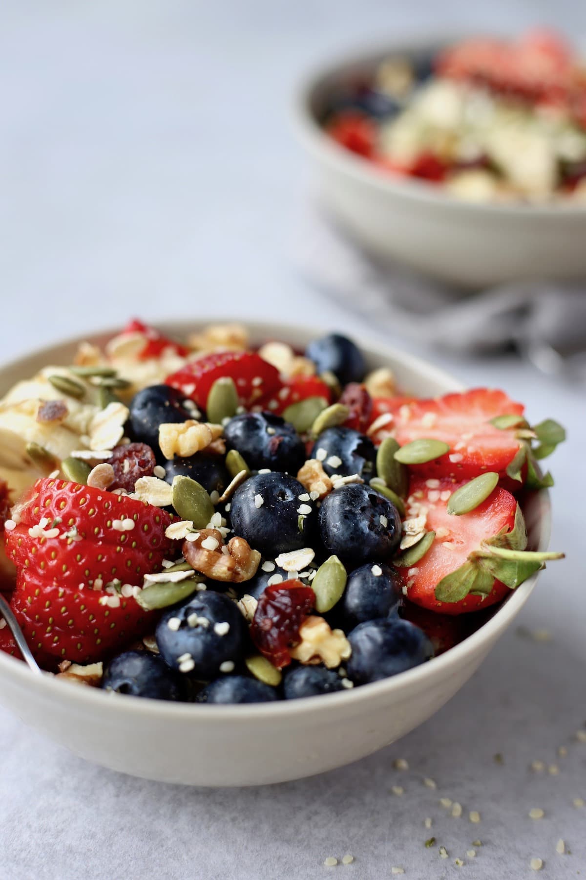 A bowl of berries, bananas, nuts and seeds