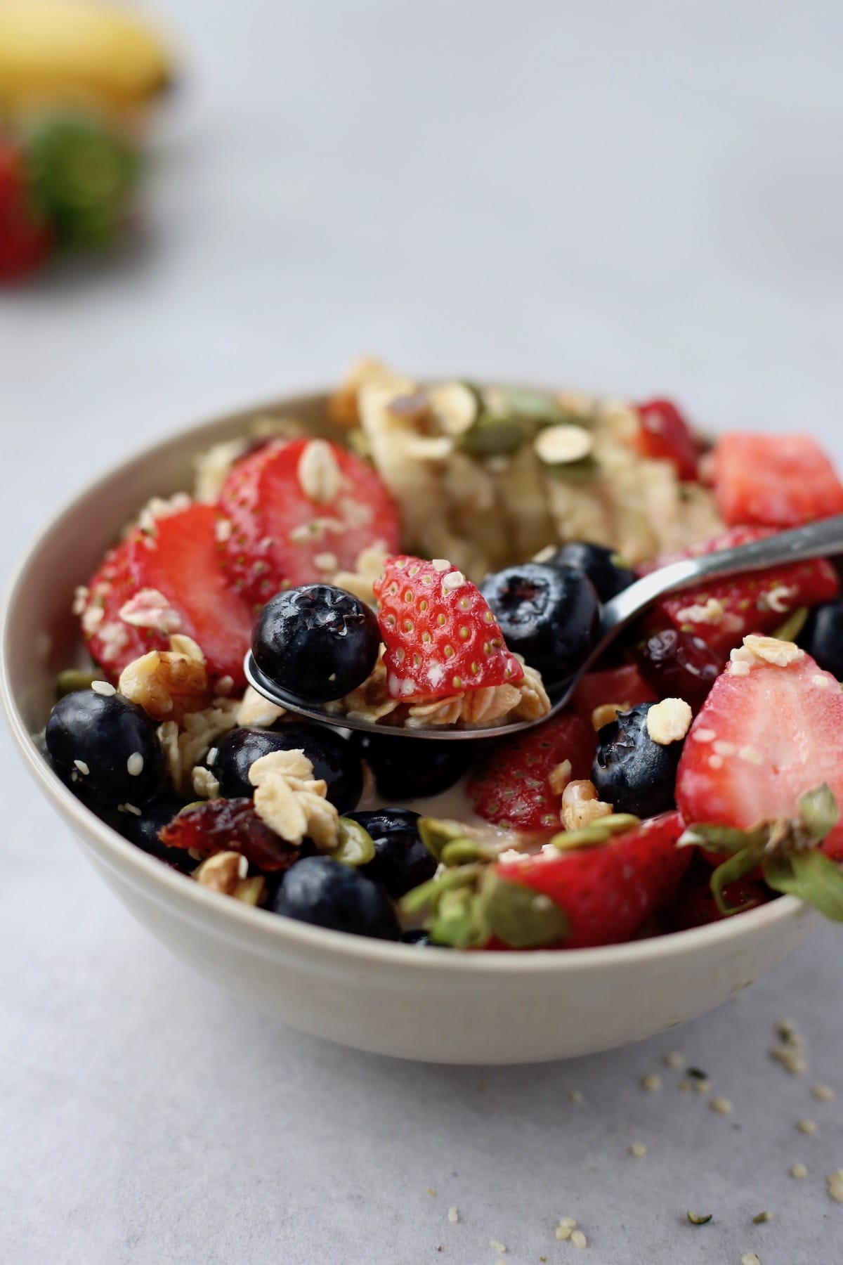 a spoon scooping up some fruit cereal