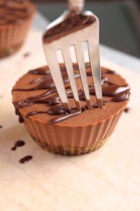 a fork cutting into a mini chocolate cheesecake