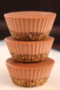 raw mini chocolate cheesecakes stacked on each other