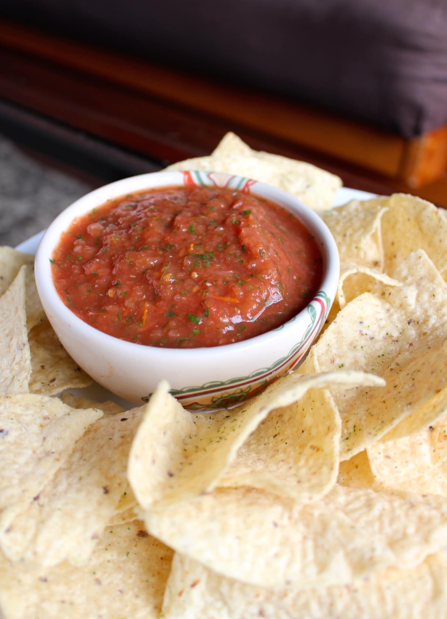 salsa in a bowl with chips around it