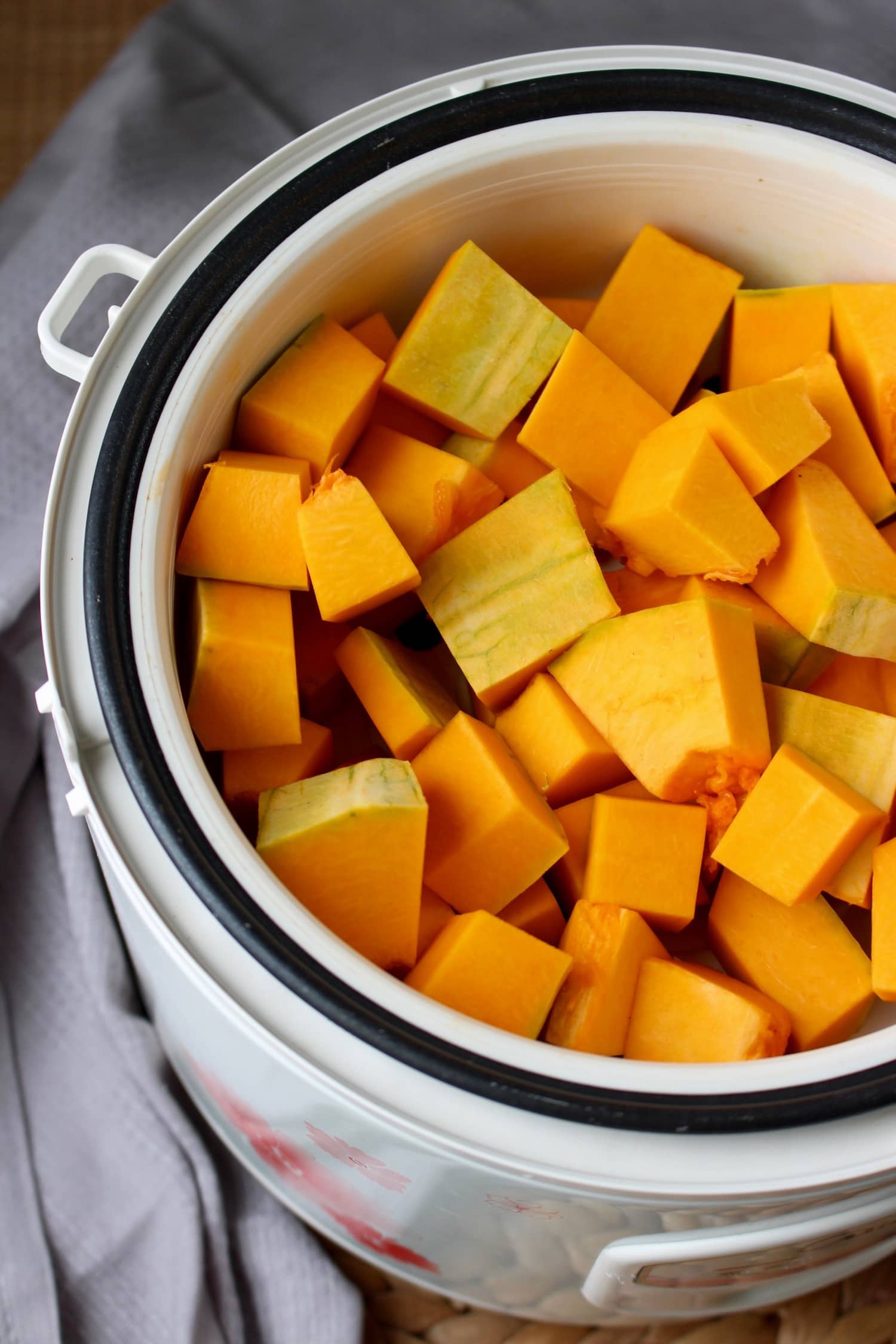 cubed pumpkin in a steamer basket