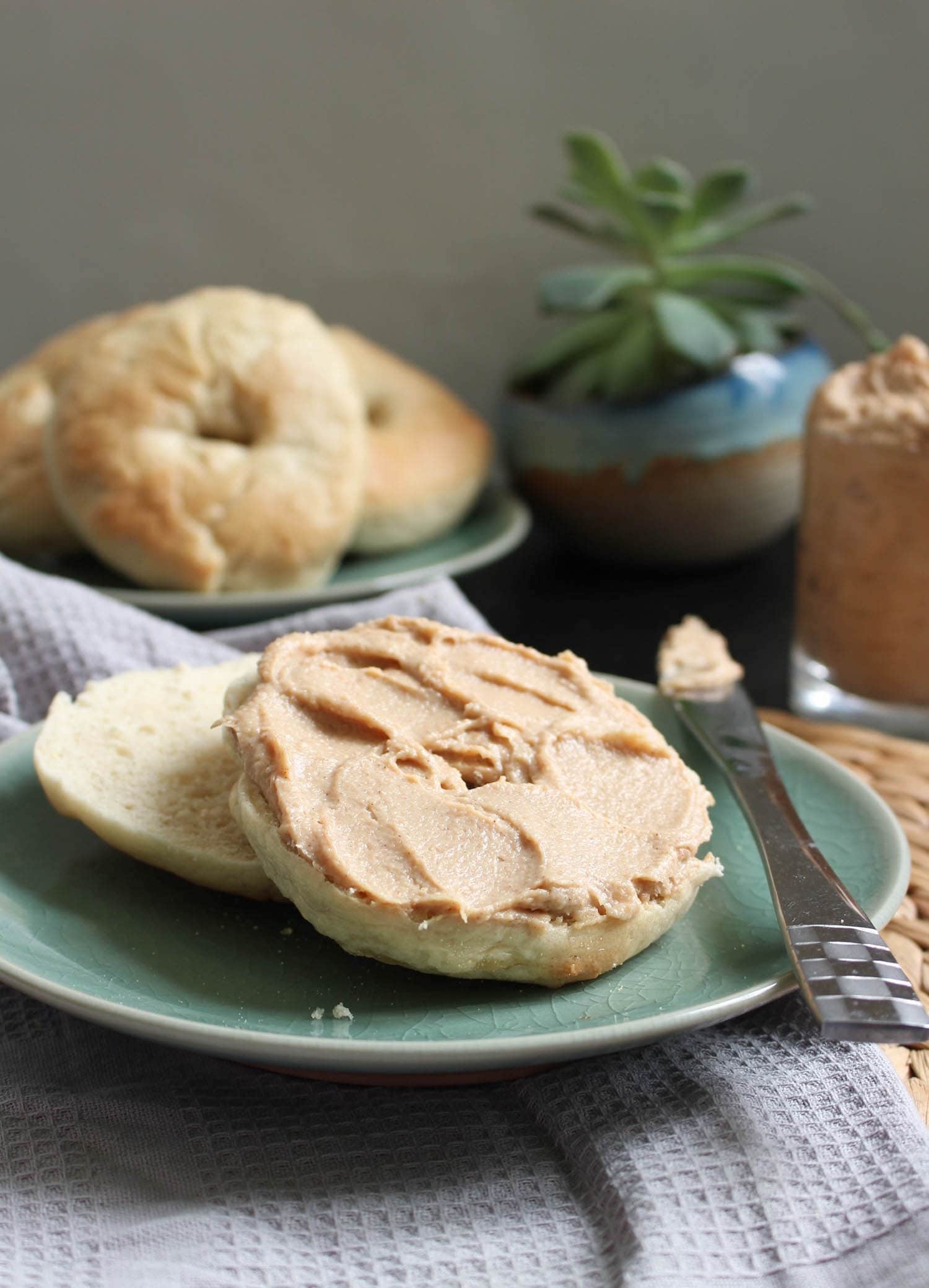 Dairy-Free Cinnamon Maple Cream Cheese swirled onto a homemade bagel