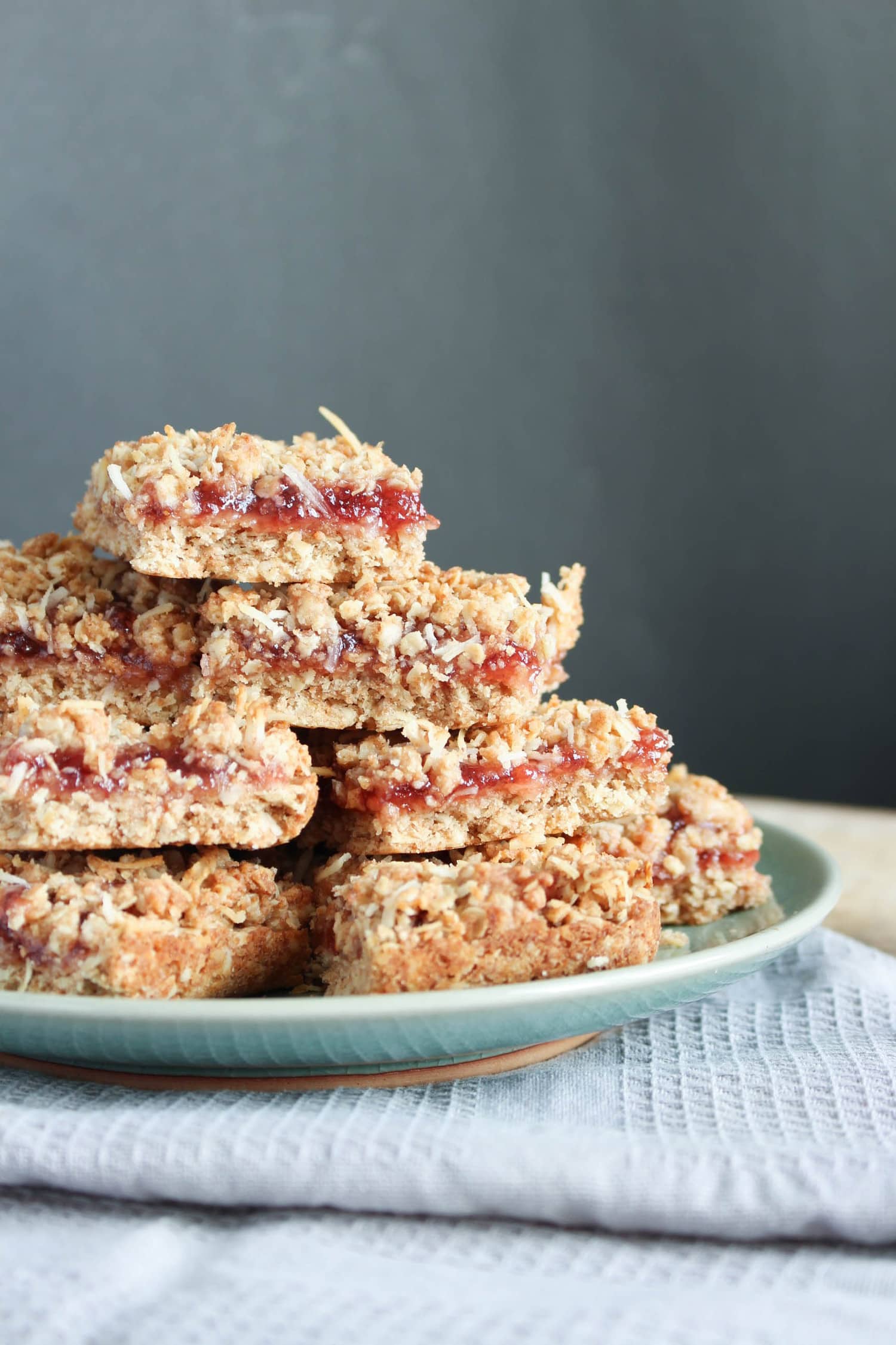 gooey Vegan Strawberry Jam Oatmeal Bars stacked on a plate