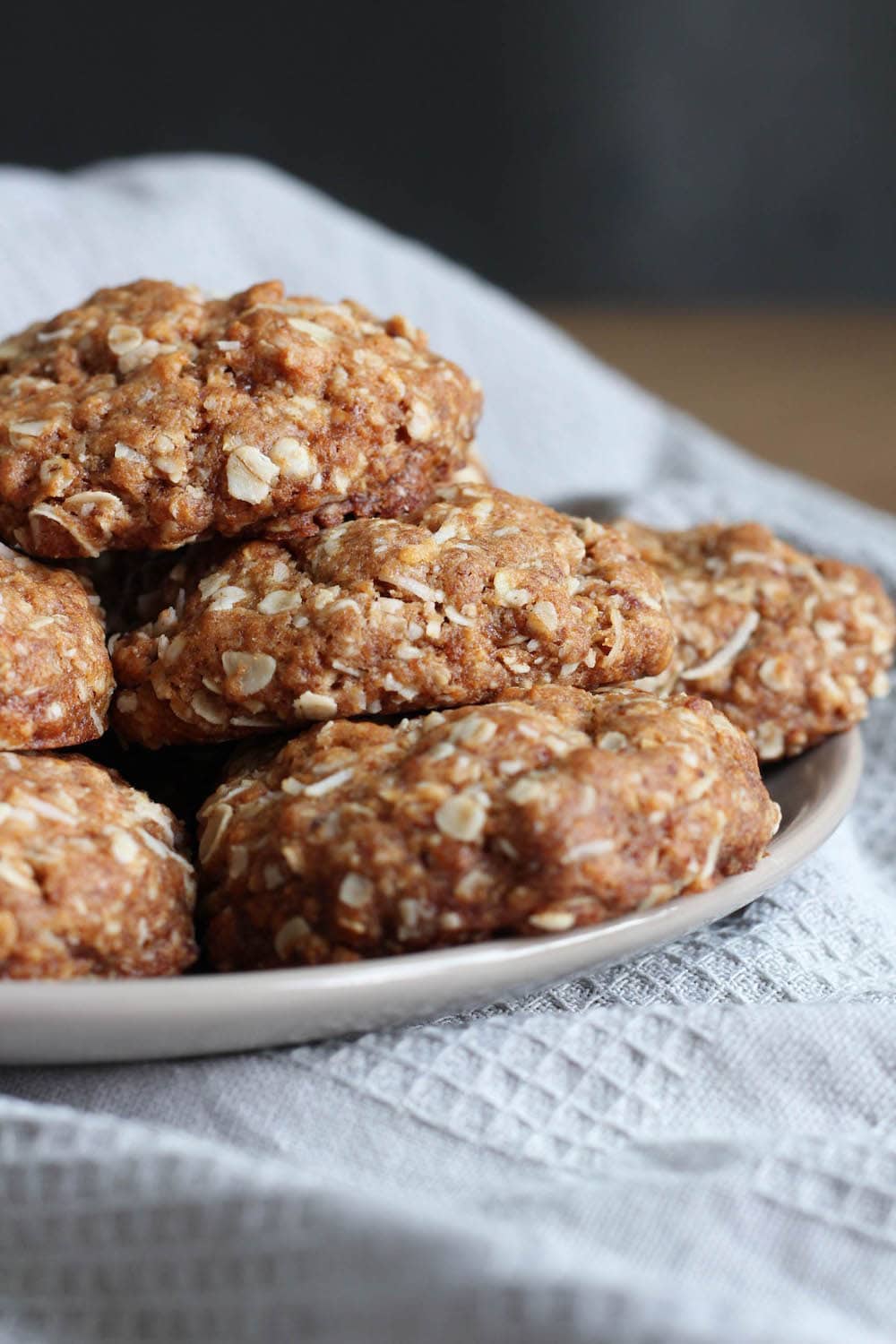 a close up of vegan coconut oatmeal cookies on a plate