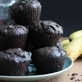 Double Chocolate Black Tahini Banana Muffins stacked on a plate