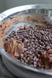 chocolate chips being added to brownie batter