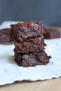 Three Vegan Zucchini Brownies stacked on each other