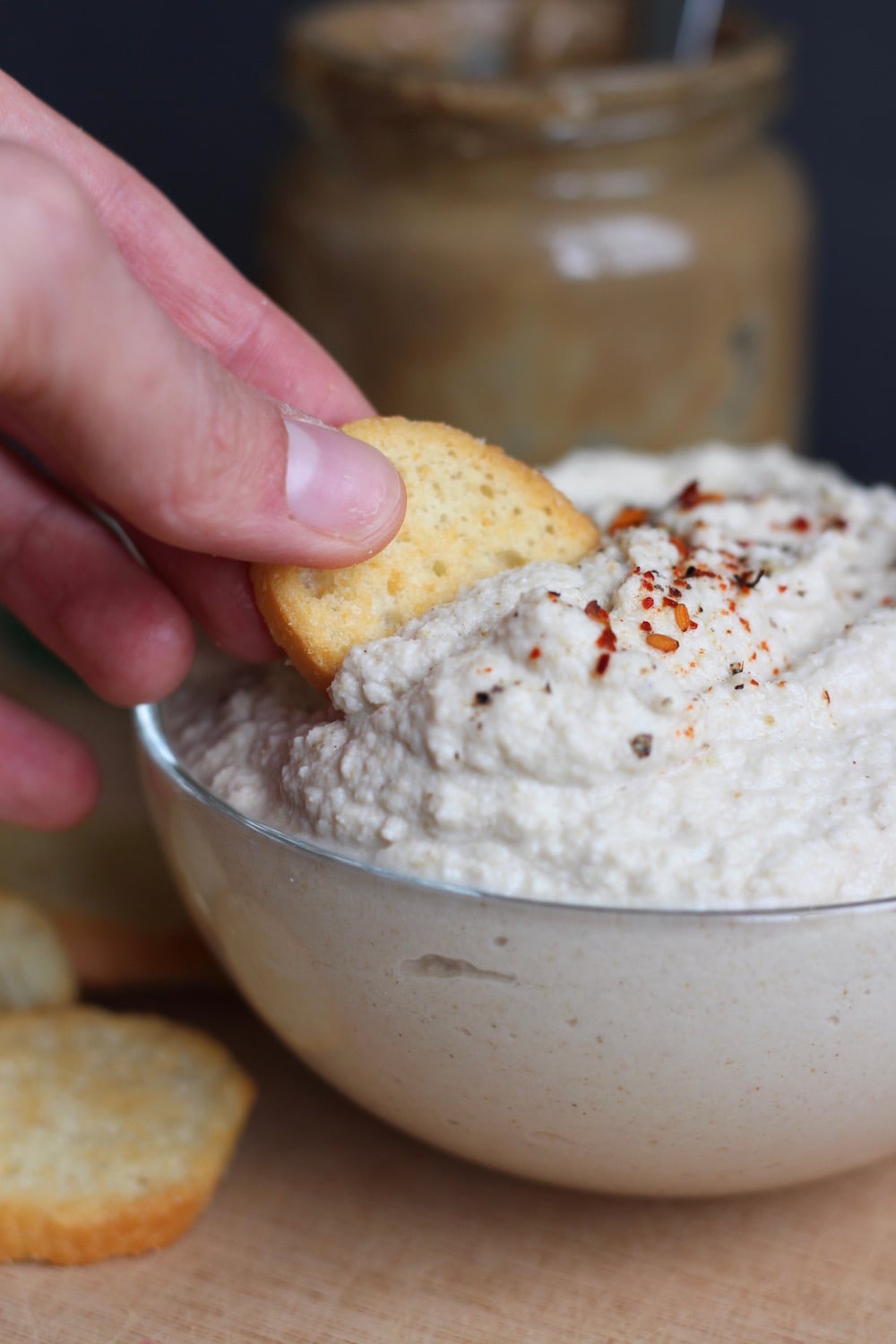 A cracker scooping up Okara (soy milk pulp) hummus