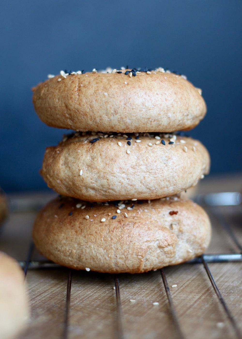 stacked Vegan Sesame Whole Wheat Bagels on food tray