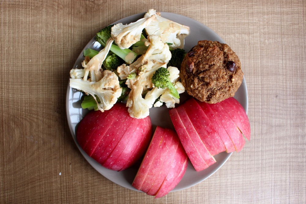 sliced apple, roasted veggies topped with peanut sauce and Oil-Free Applesauce Oat Bran Muffin