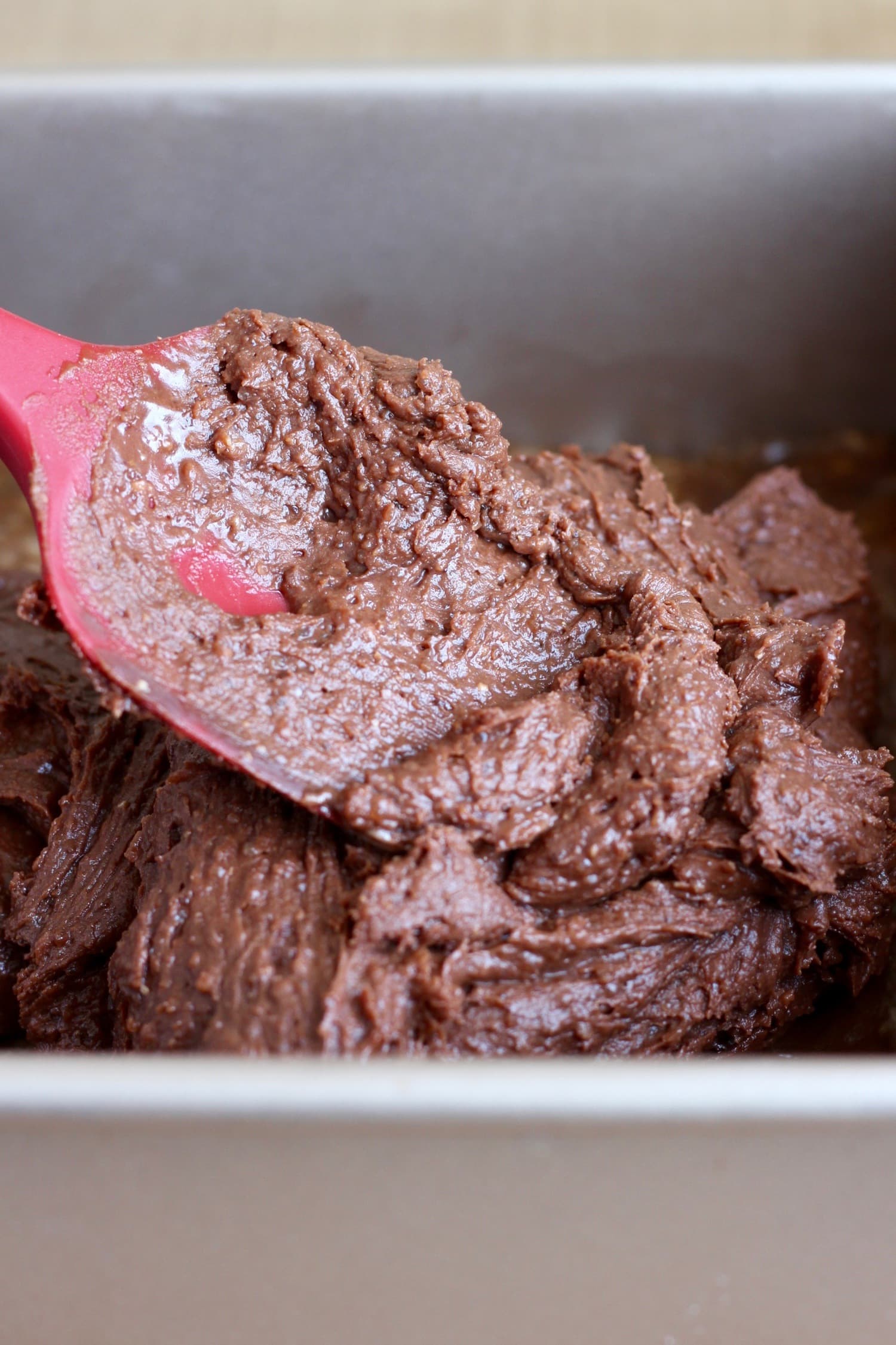 Chocolate Brownie Batter being spread in pan