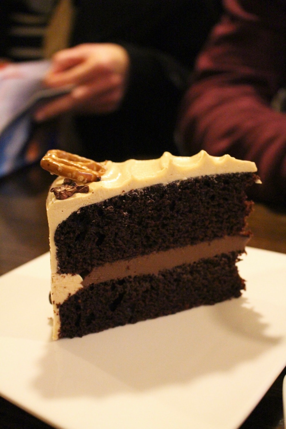 chocolate cake with ganache and pretzel on top