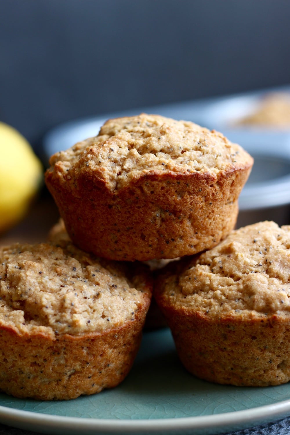 Vegan Lemon Poppy Seed Muffins stacked on a plate