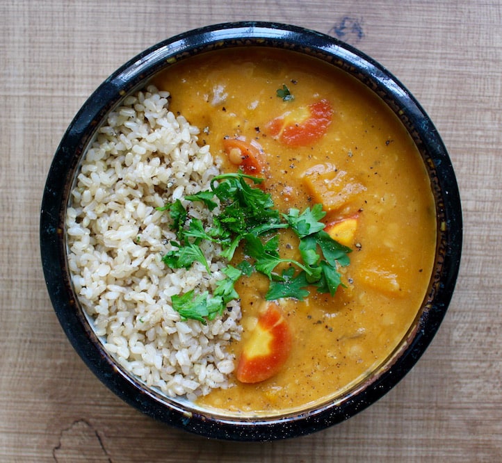 Red Lentil Pumpkin Soup served with brown rice and cilantro