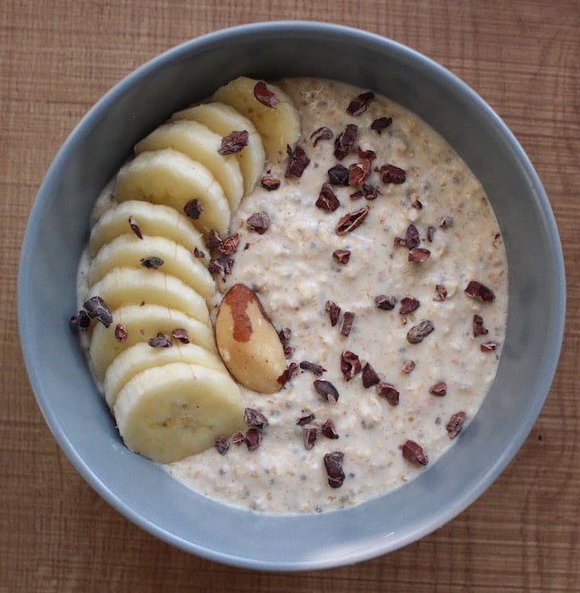 overnight oats topped with with banana, cacao nibs and a brazil nut