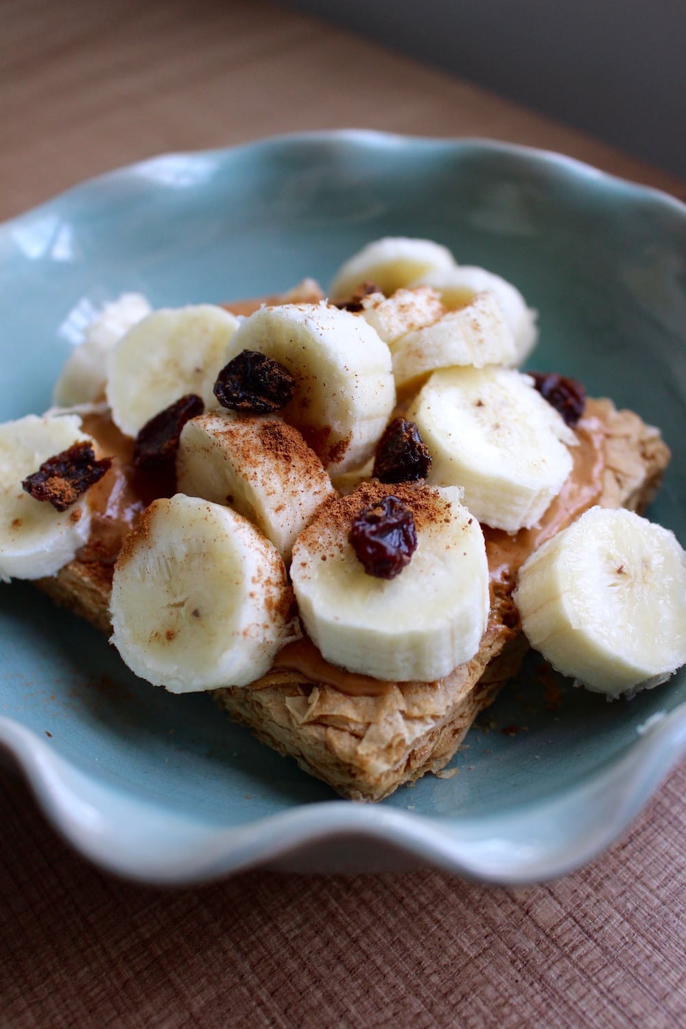 Weetabix with cashew butter, a sliced banana and some raisins