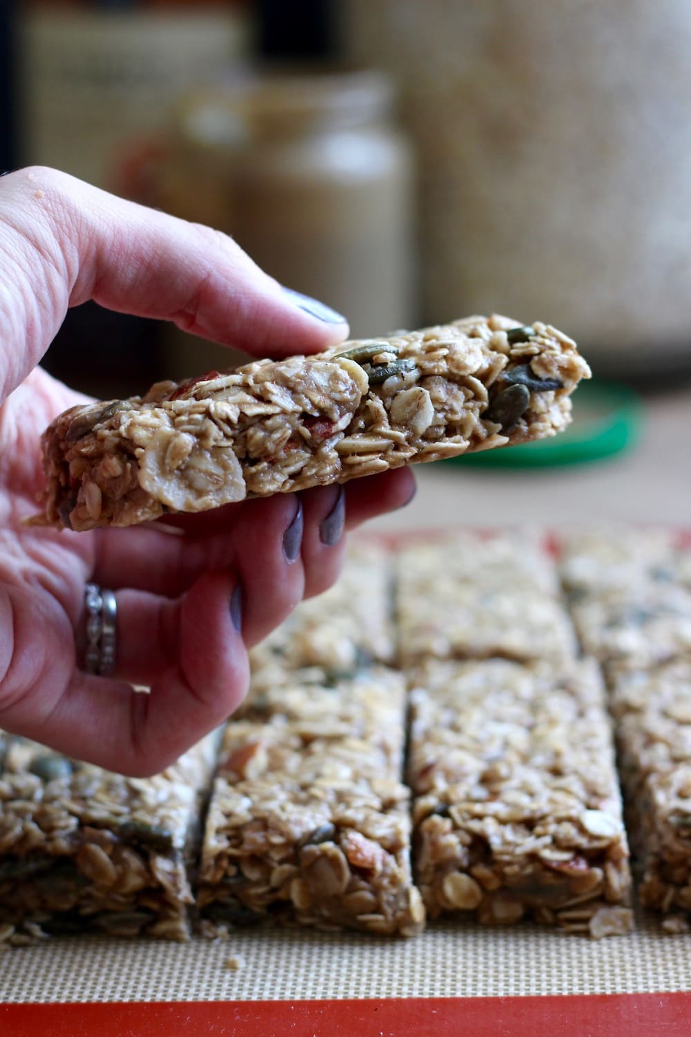 holding a piece of Tahini Oatmeal Granola Bar