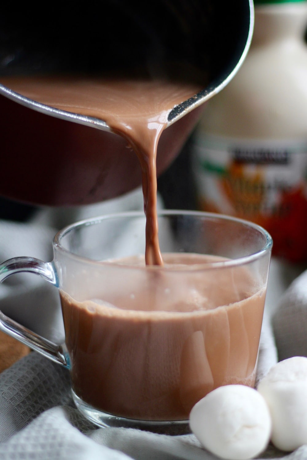pouring the Homemade Cashew Milk Hot Chocolate into a cup