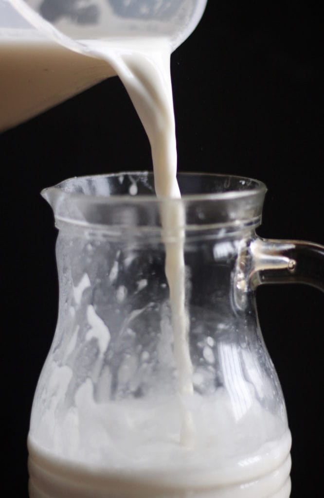 Homemade Cashew Milk being poured into a pitcher