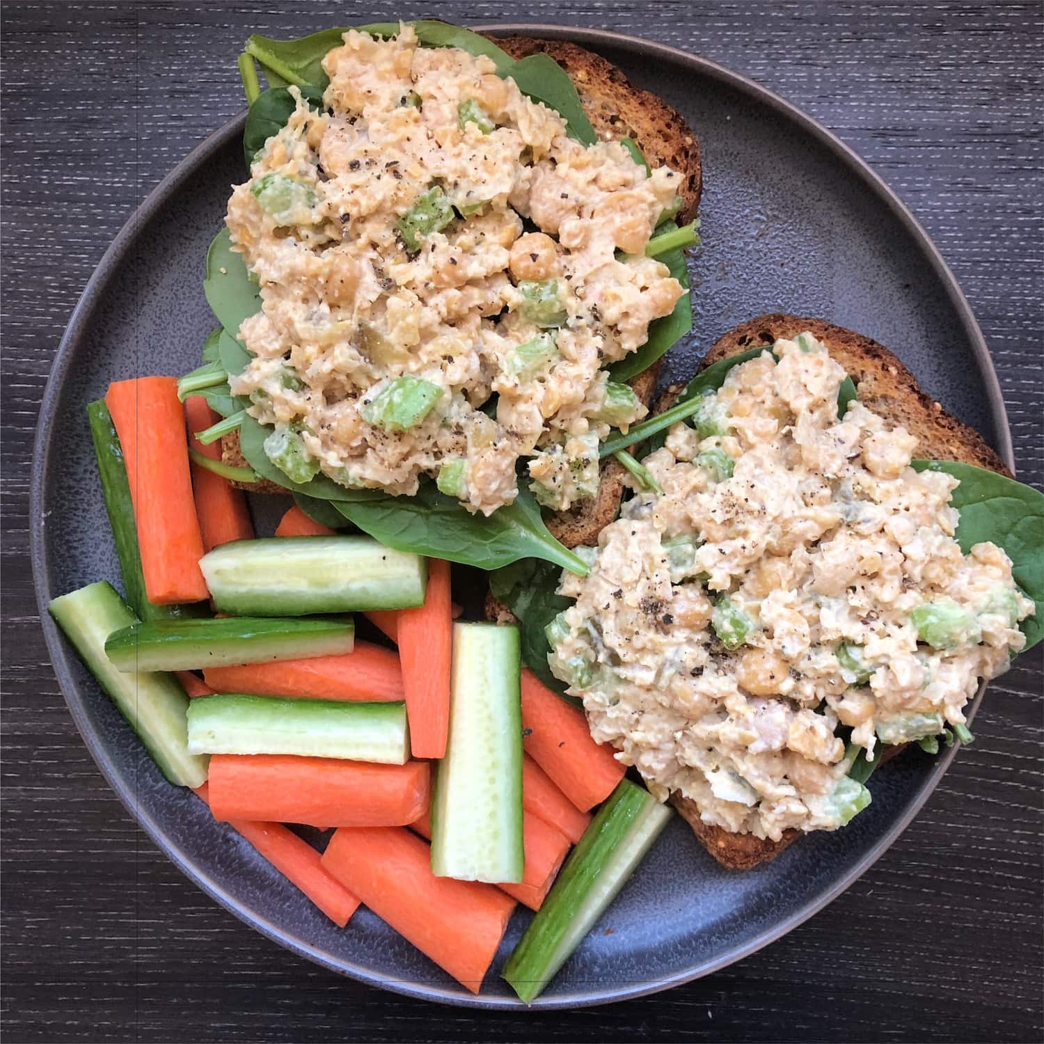 Vegan Tahini Chickpea Salad on toast with cucumbers and carrots