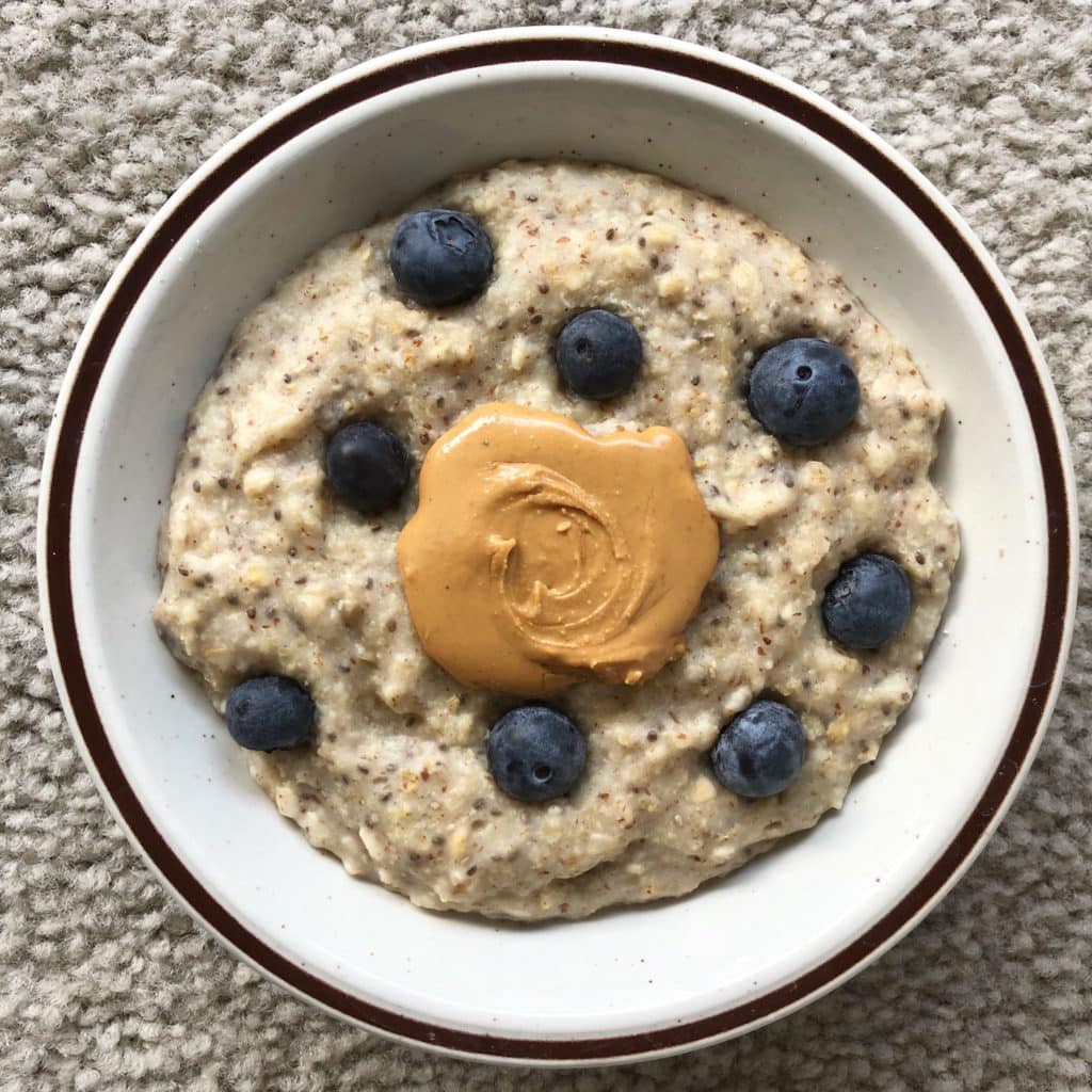 Basic chia and flax oats topped with blueberries and cashew butter