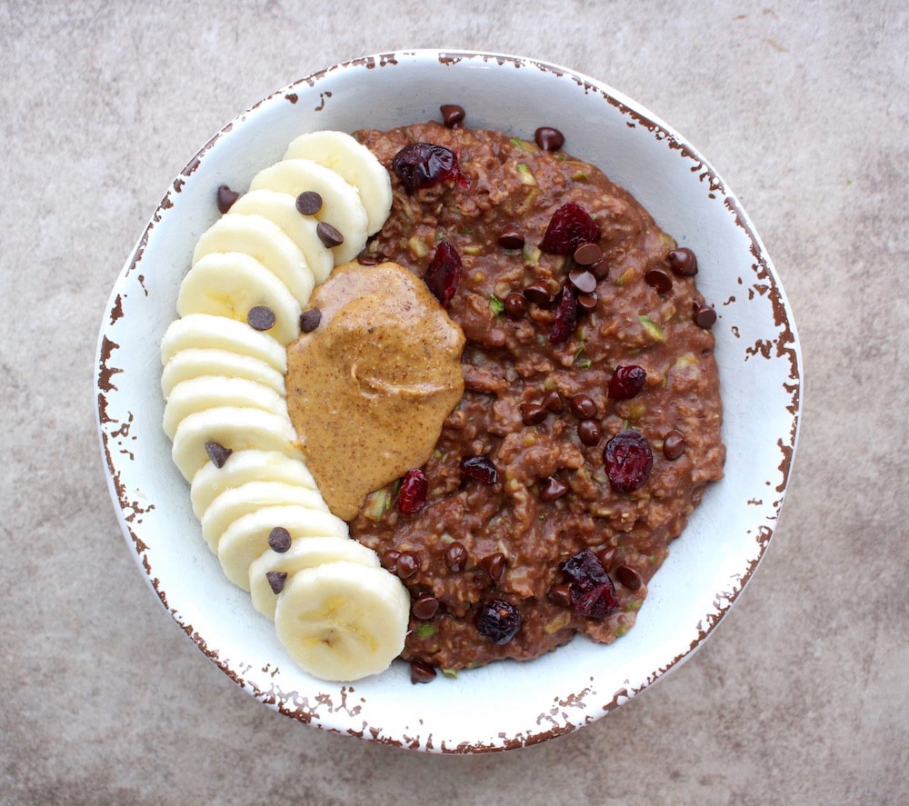 Chocolate zoats topped with banana, mini chocolate chips, craisins and almond butter