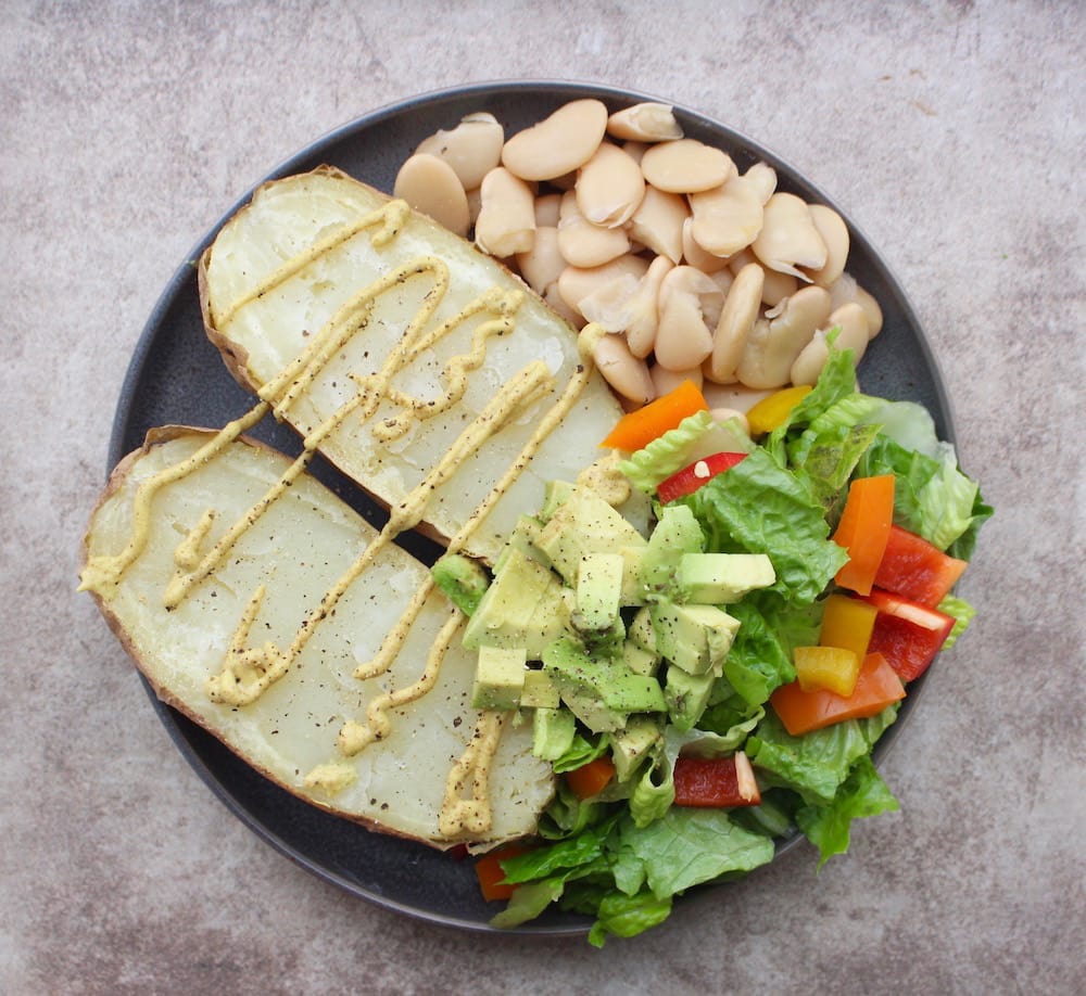 Baked potato, butter beans and simple salad with avocado and dijon mustard as condiments