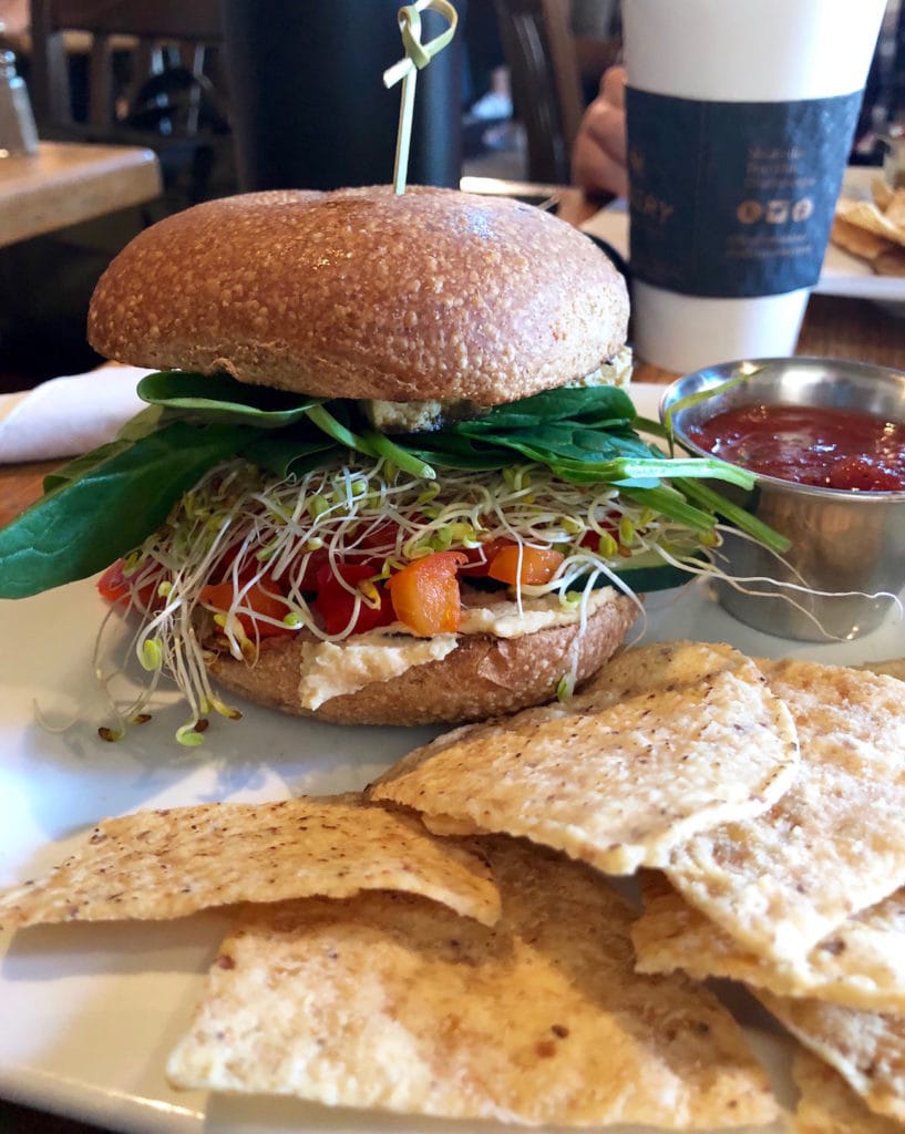 a bagel and hummus sandwich from The Frothy Monkey