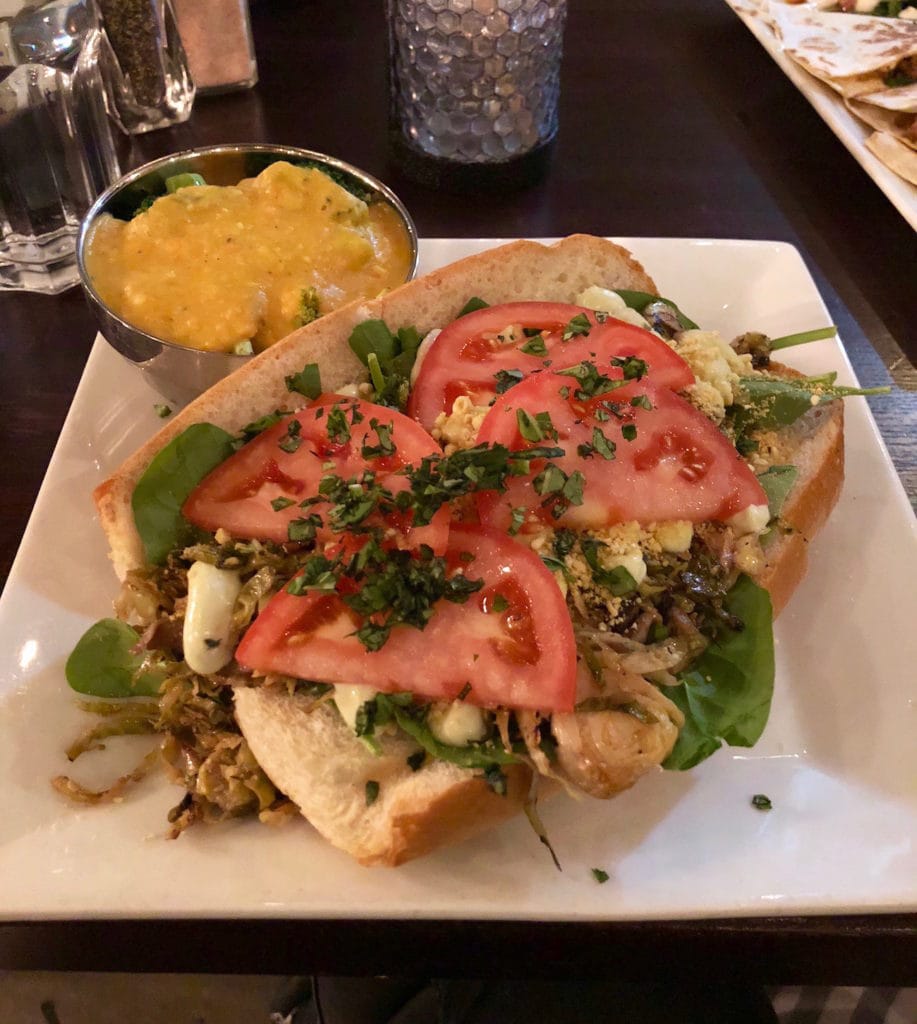 shaved brussels sprouts and mushroom pesto sandwich with a side of cheesy broccoli