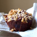 Vegan Chocolate Banana Muffins with Pecan Streusel on a plate with napkin underneath