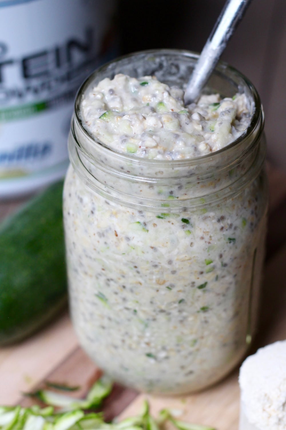 a jar of creamy protein overnight oats with zucchini in it