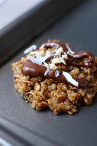 Close up of chocolate drizzle and coconut flakes on a no bake cookie