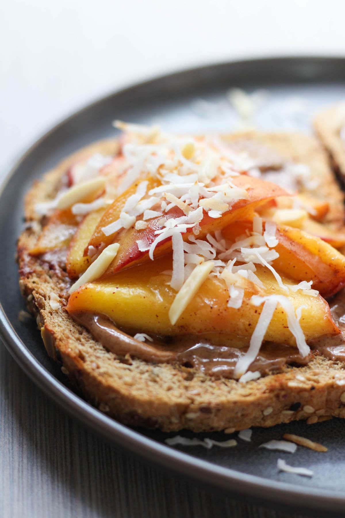 crispy toast topped with almond butter and sauteed peaches