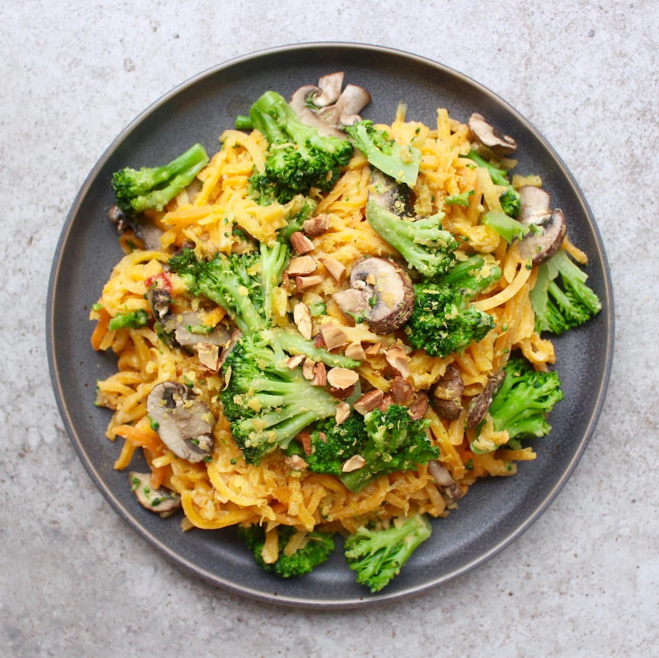 Microwaveable cheese butternut squash noodles with broccoli and mushrooms