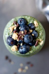 Green Superfood Overnight Oats topped with berries and granola