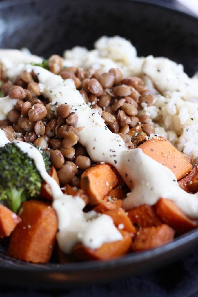 buddha bowl with carrots broccoli rice and vegan miso tahini dressing