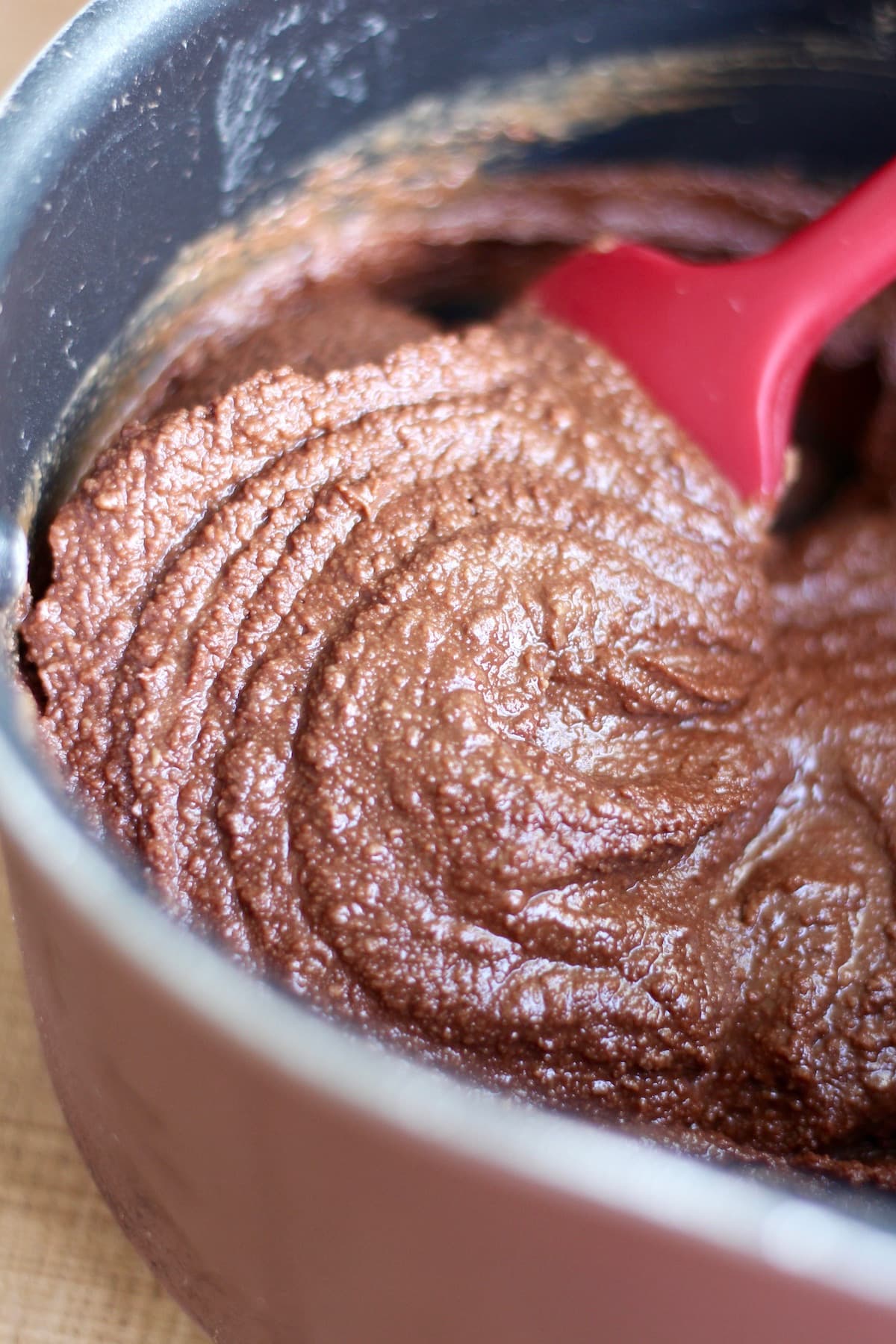 melted chocolate and tahini mixed together in a bowl