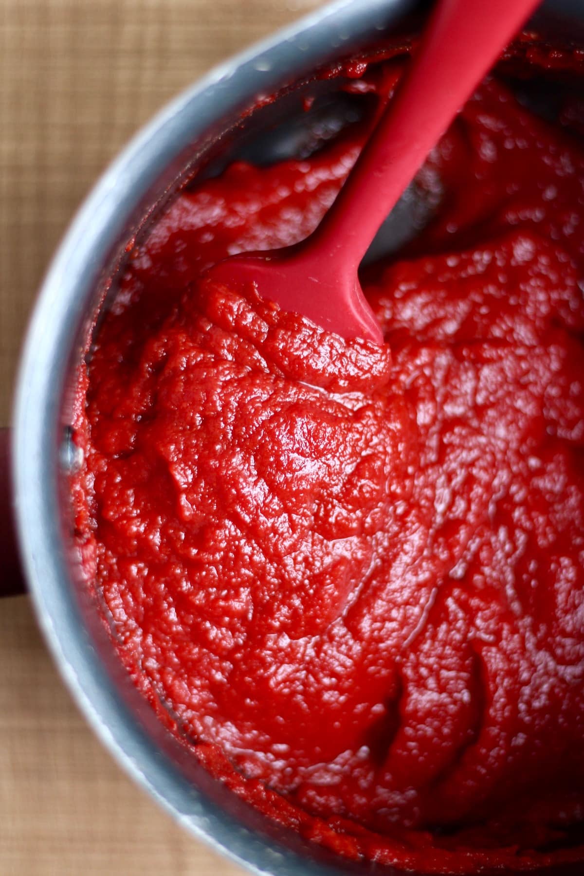 homemade ketchup being stirred in a saucepan