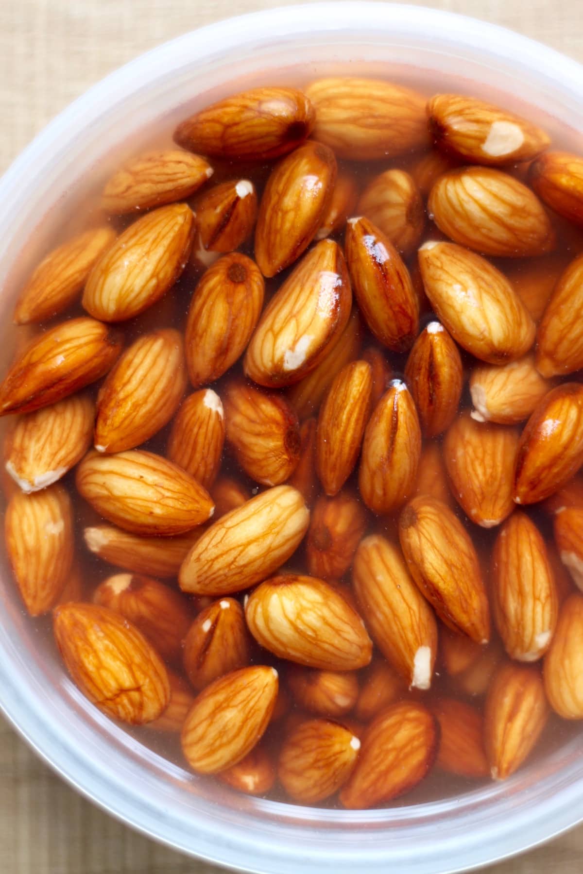 Almonds soaking in tupperware for homemade almond milk