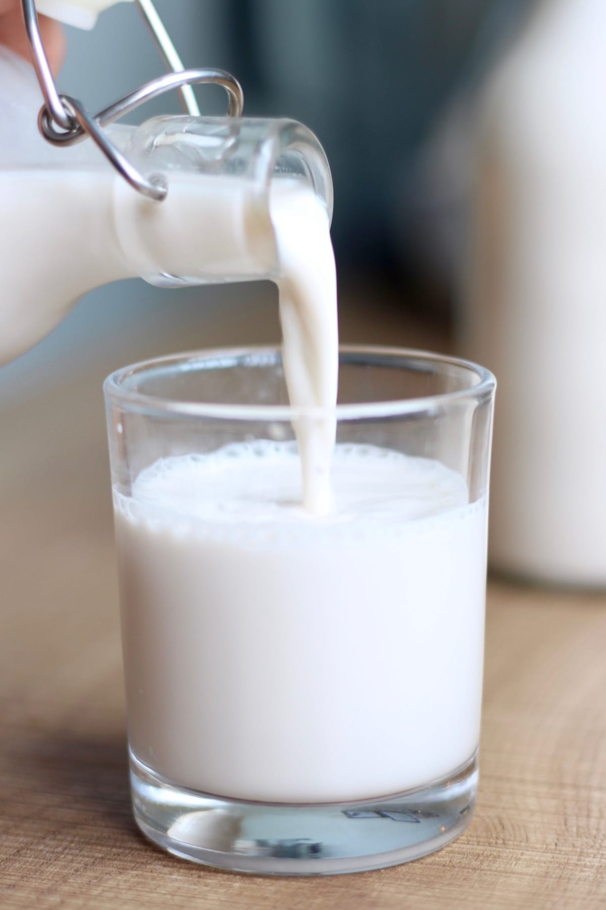 Pouring homemade almond milk into a glass