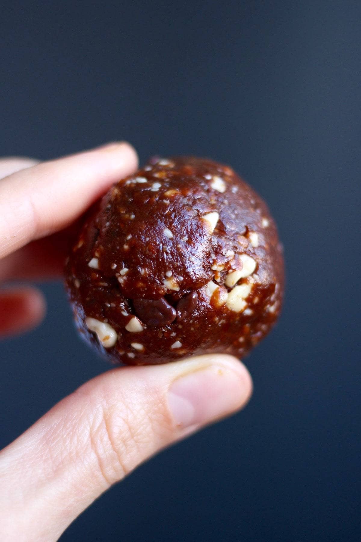 a Chocolate Orange Bliss Ball held in the air