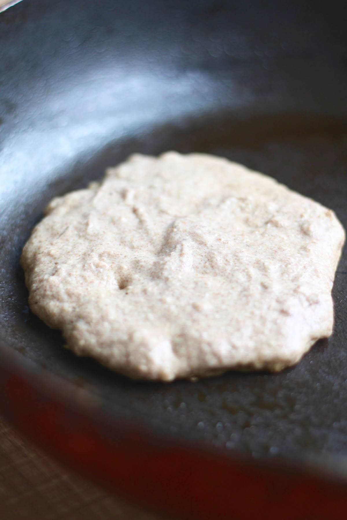 pancake batter cooking on a skillet