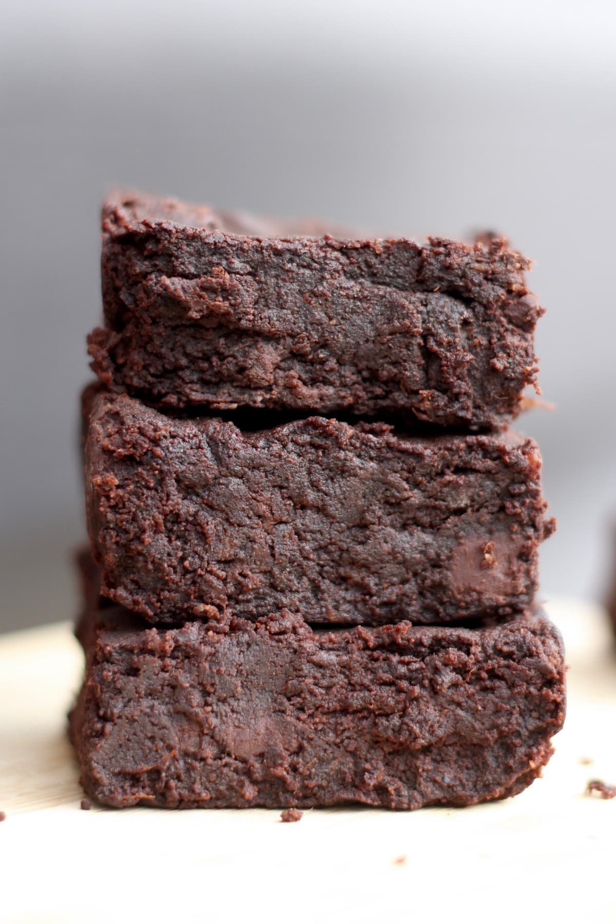 Three fudgy sweet potato brownies stacked on each other.