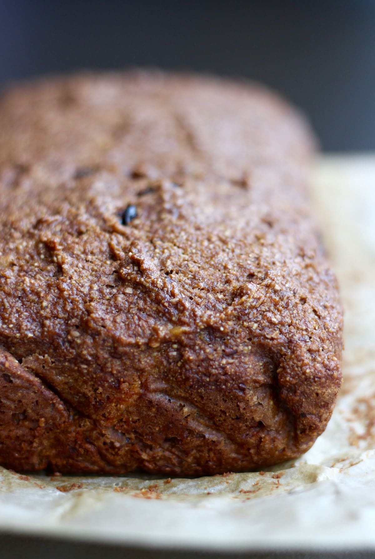 vegan gingerbread loaf cooling on parchment paper